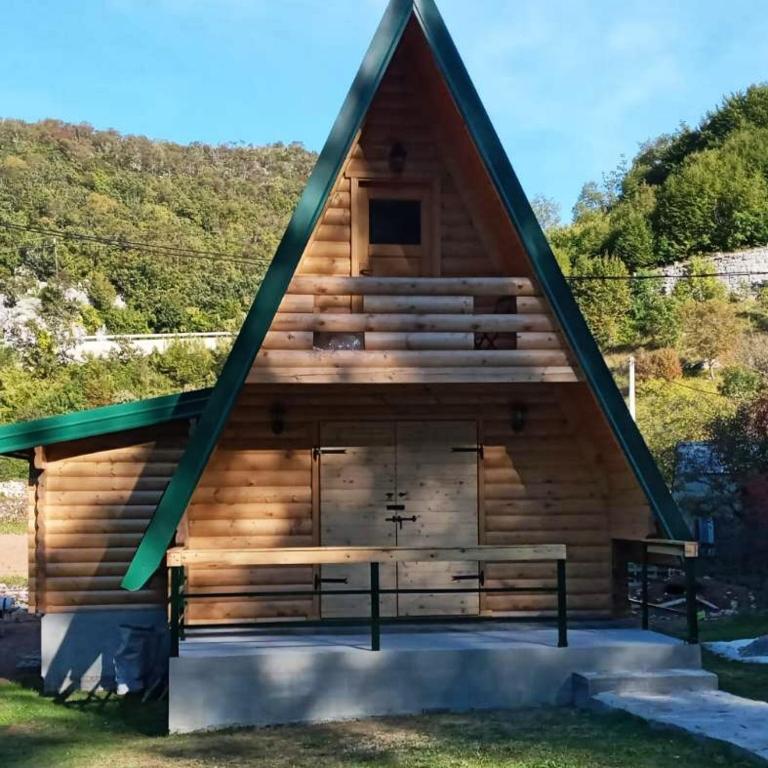 a large log cabin with a pitched roof at Nice&cosy cabin in Cetinje