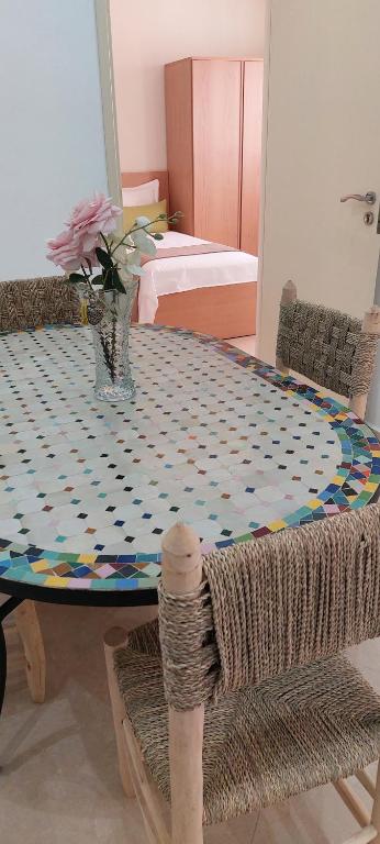 a dining room table with a patterned table cloth at Essaouira Cool apartments in Essaouira