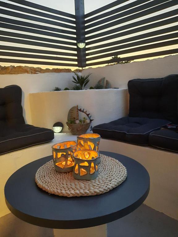 a table with three orange bowls on top of it at Mandrina House in Mandre