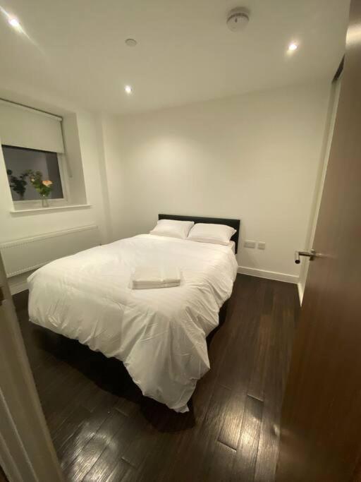 Tempat tidur dalam kamar di 2 BR Flat in Sutton London NH70