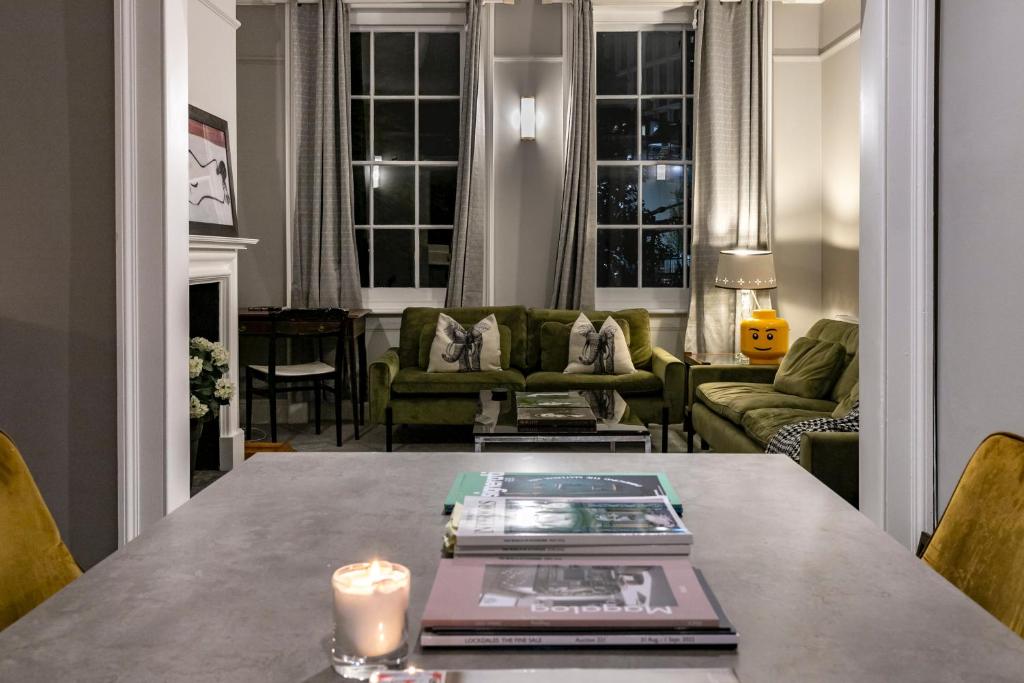 a living room with a table with a candle on it at Shared Guest House 5 mins walk from Vauxhall and Nine Elms Station with off-site parking near US embassy in London