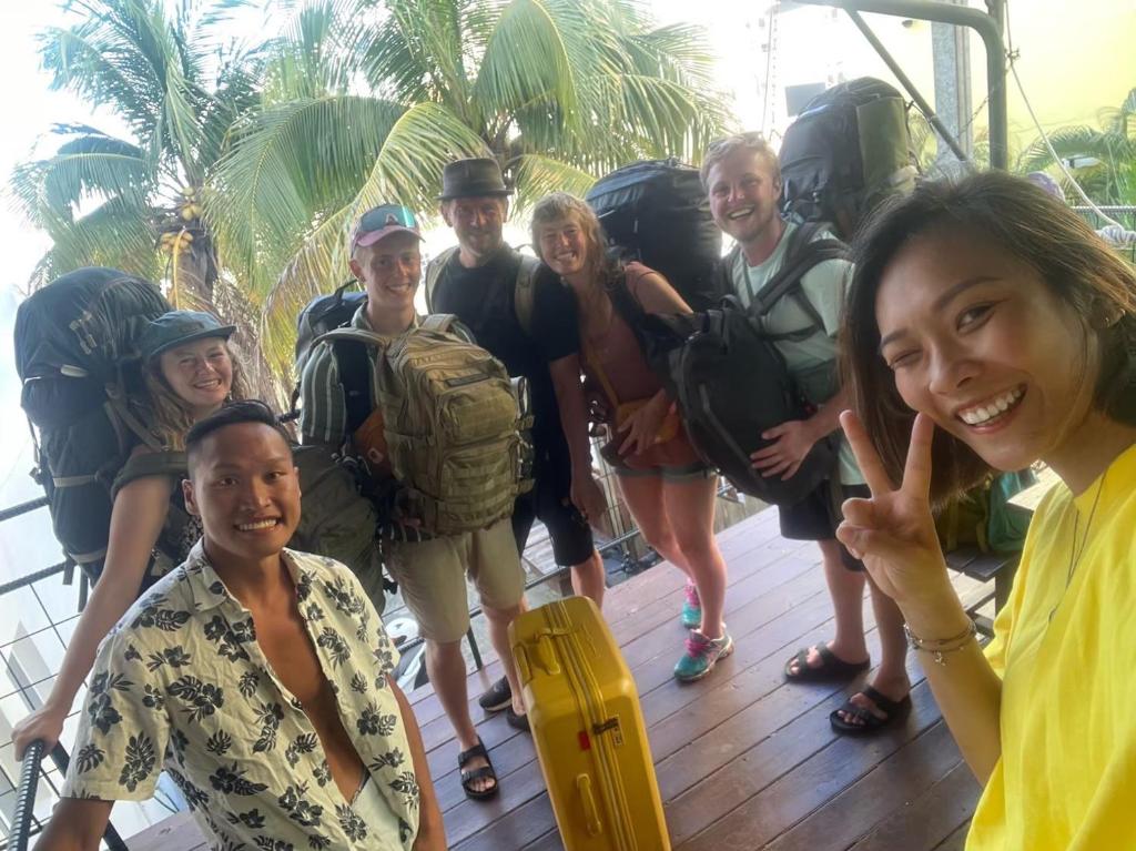 a group of people posing for a picture on a boat at Kenting Original Hostel in Kenting