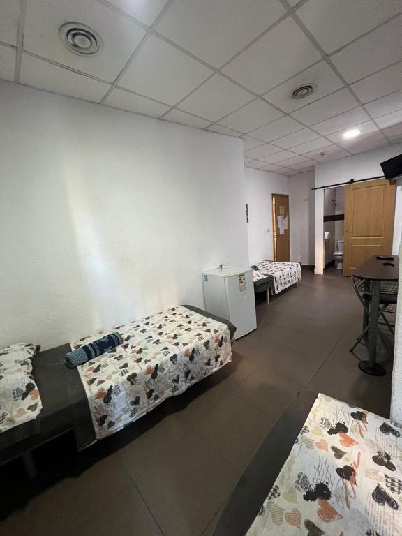 Postel nebo postele na pokoji v ubytování Hostal Milan