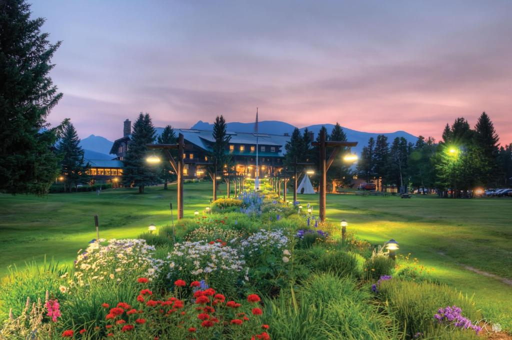 a garden with flowers in front of a building at Glacier Park Lodge in East Glacier Park