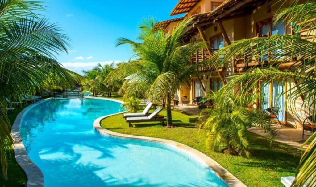 a swimming pool in front of a resort at Apartamento 320 Praia Bonita Resort in Nísia Floresta