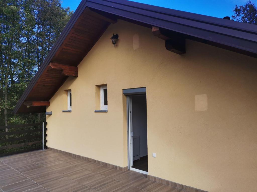 a small house with a door and a deck at Kuća za odmor- Milošev Konak Banja Luka 