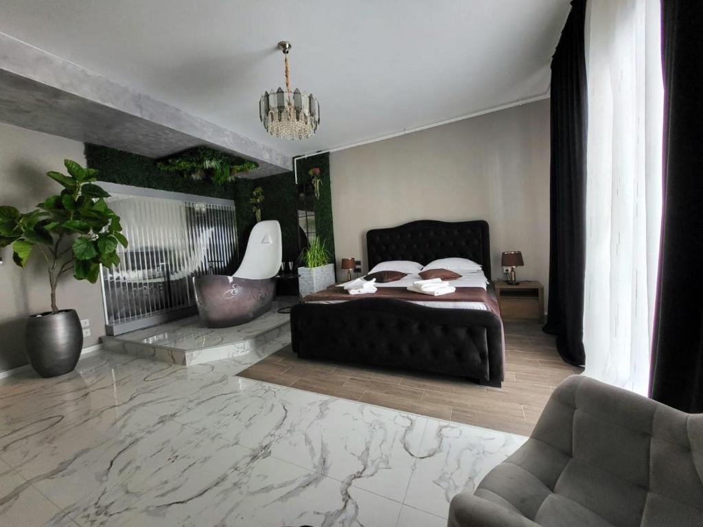 a bedroom with a bed and a couch and a chair at Studio Casa del Mar - Mathi in Mamaia