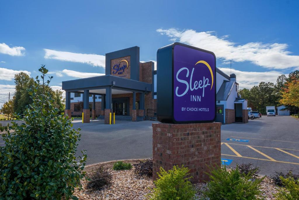 a sign in front of a store in a parking lot at Sleep Inn Madison in Madison