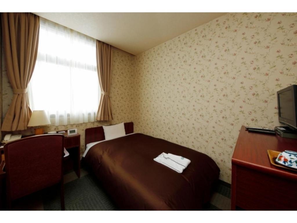 En eller flere senge i et værelse på Zentsuji Grand Hotel - Vacation STAY 16623v