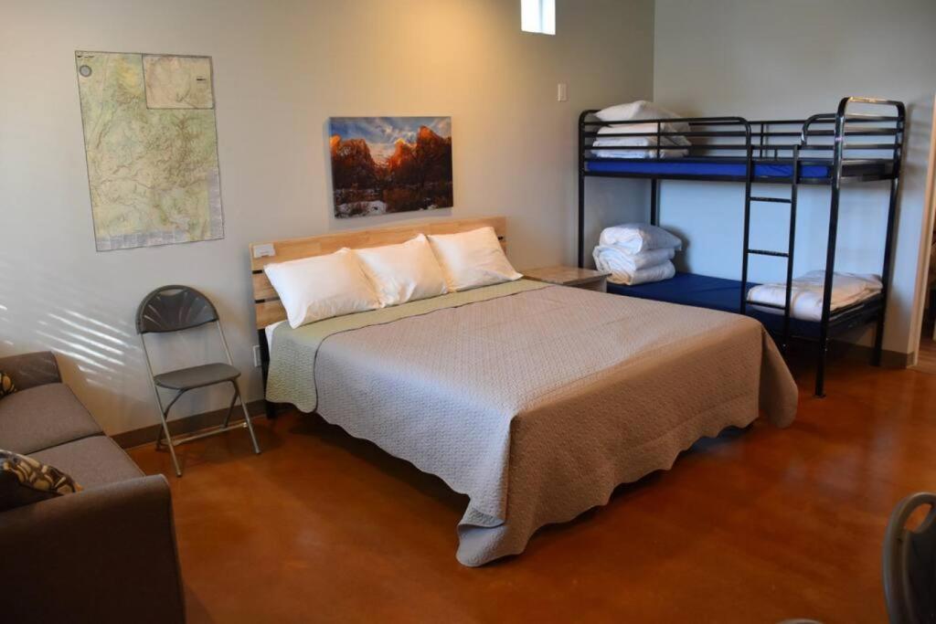 a bedroom with a bed and two bunk beds at Bunkhouse 9A Close To Zion And Bryce Canyon in La Verkin