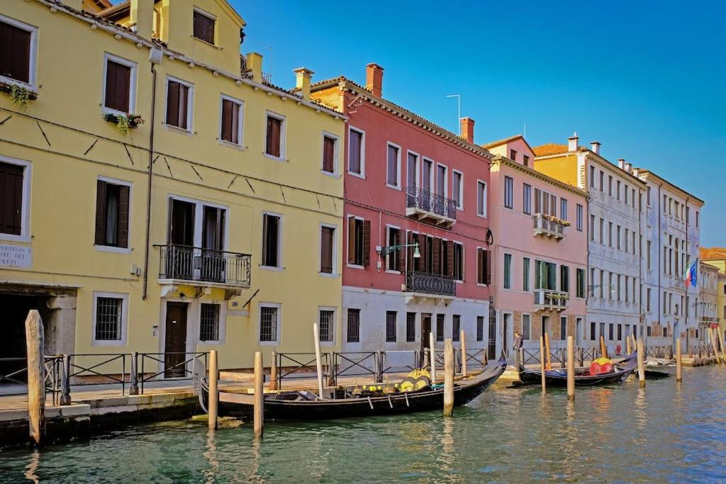 a row of colorful buildings next to a canal at Apt Ponte Dei Greci in Venice