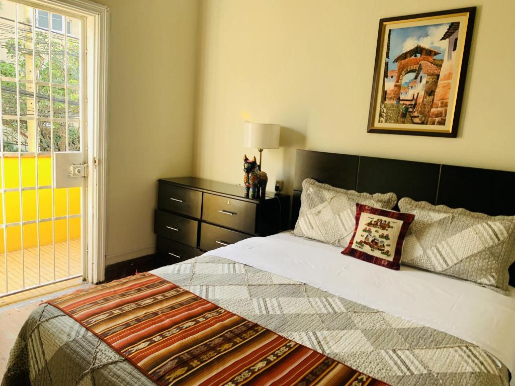 a bedroom with a large bed and a window at Peruvian House - Miraflores in Lima