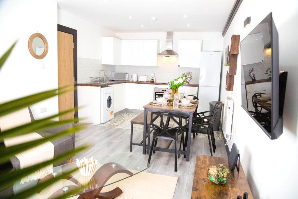 a kitchen and dining room with a table and chairs at Manchester Apartments by BEVOLVE - Free Parking in Manchester