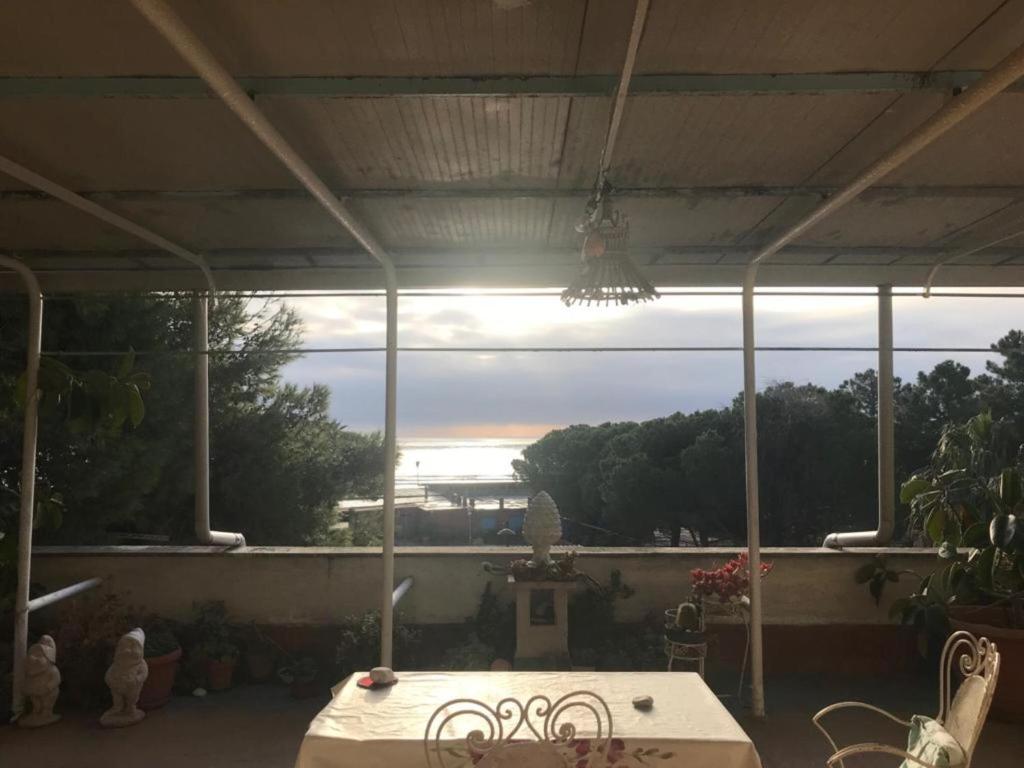 a patio with a table and a large window at Casa Patrizia in Villapiana