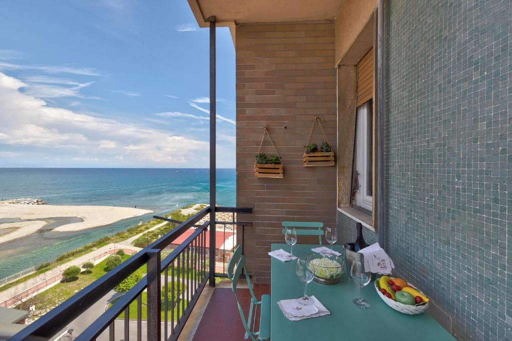 a balcony with a table and a view of the ocean at Riva Mare 1 in Vado Ligure