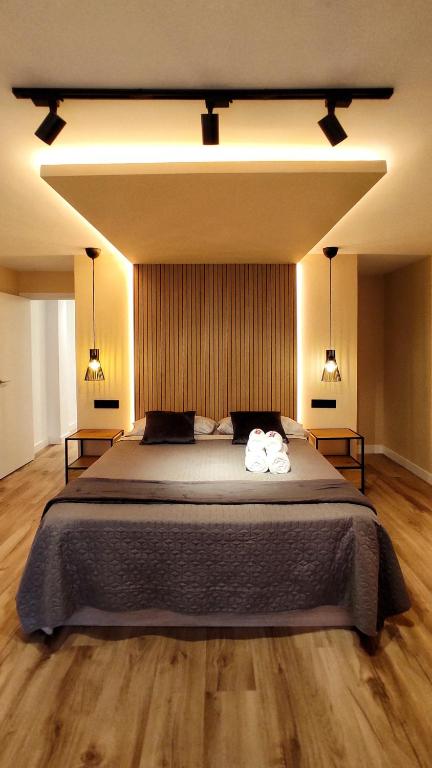 a bedroom with a large bed with two towels on it at Apartamento en el casco historico de Betanzos in Betanzos