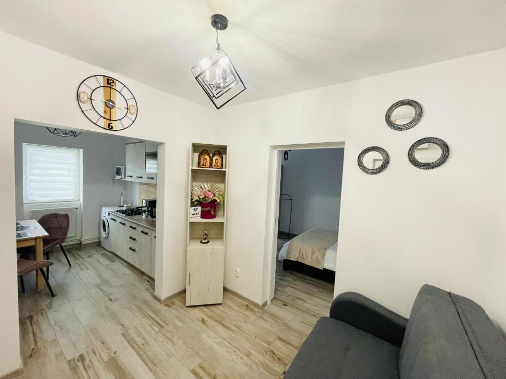 a living room with a couch and a bedroom at Apartament CHIC in Vatra Dornei