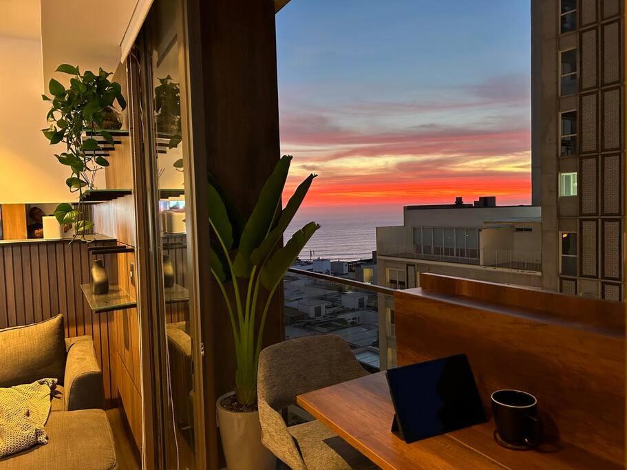 a room with a table and a view of the ocean at Apartamento vista al mar, Barranco, The Modern in Lima