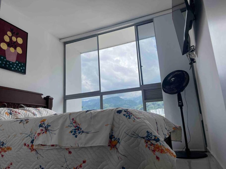 a room with a large window with a couch and a lamp at Espacio acogedor en Piedecuesta, Santander. in Piedecuesta