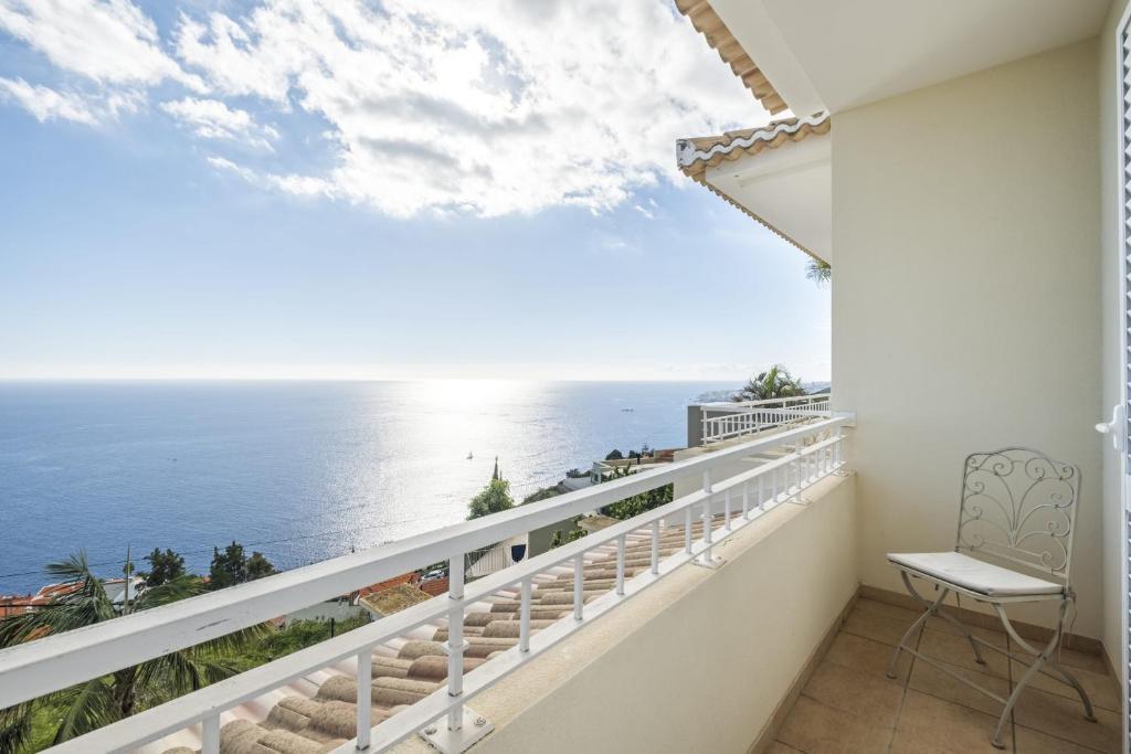 a balcony with a view of the ocean at Capela - Casa das Neves in Funchal