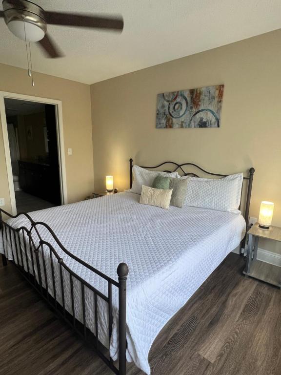 a bedroom with a large bed with a white comforter at Camden Grandview! Spacious 2 Bed, 2 Bath Uptown Gem in the Heart of the City-Parking-Wi-Fi in Charlotte