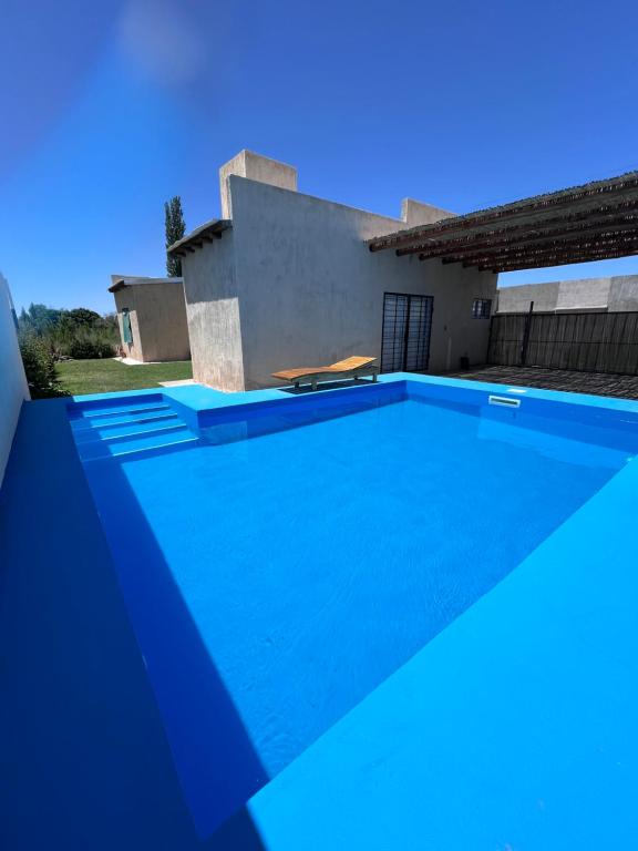 a swimming pool in front of a house at Casa con pileta privada in General Alvear