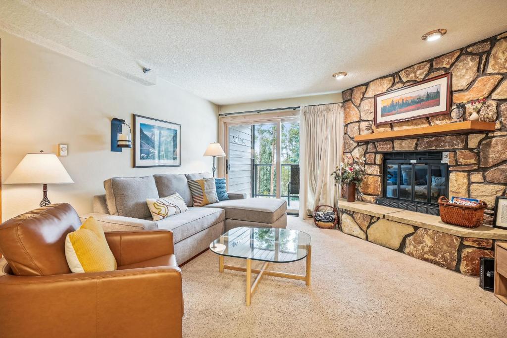 a living room with a couch and a fireplace at Atrium 106 in Breckenridge
