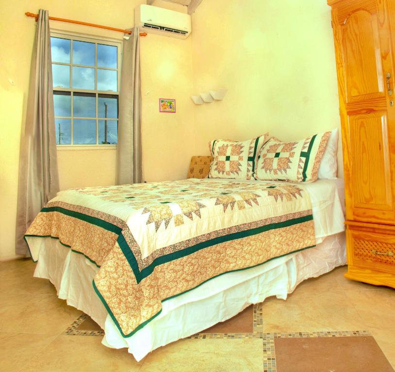 a bedroom with a bed and a window at Cozy Modern Upstairs 2 Bed A/C Apt Near 2 Everything in Saint Philip