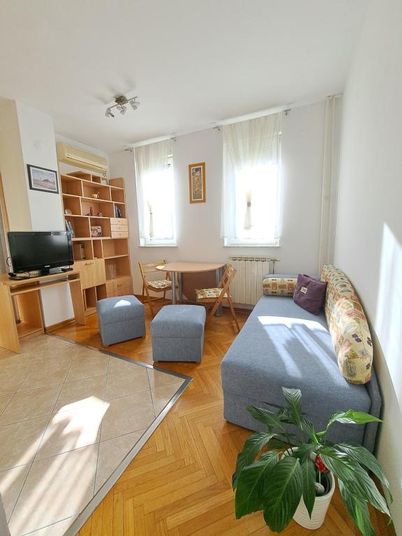 a living room with a couch and a table at Ramonda in Belgrade