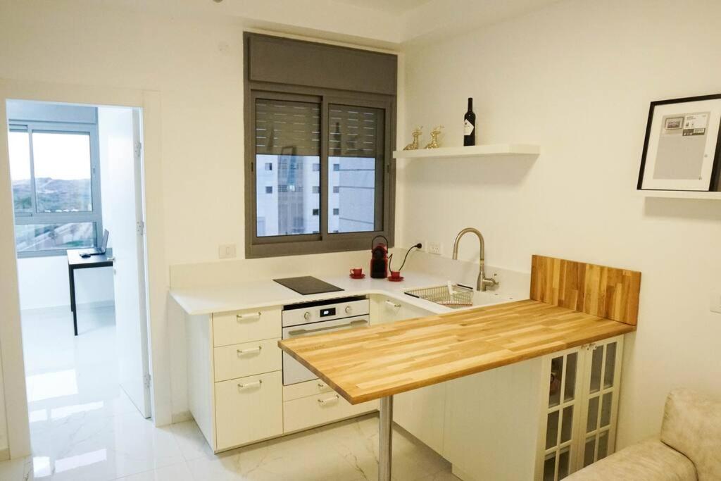 a kitchen with a sink and a counter top at Waves Project in Acre