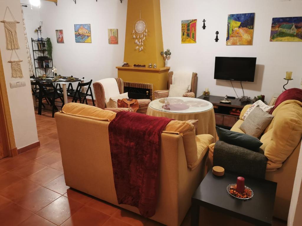 ein Wohnzimmer mit 2 Sofas und einem Tisch in der Unterkunft Casa rural Cañaveral de León in Cañaveral de León