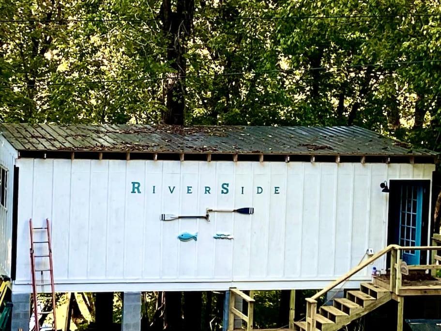 a white shed with the words riverside on it at Riverside in Tazewell