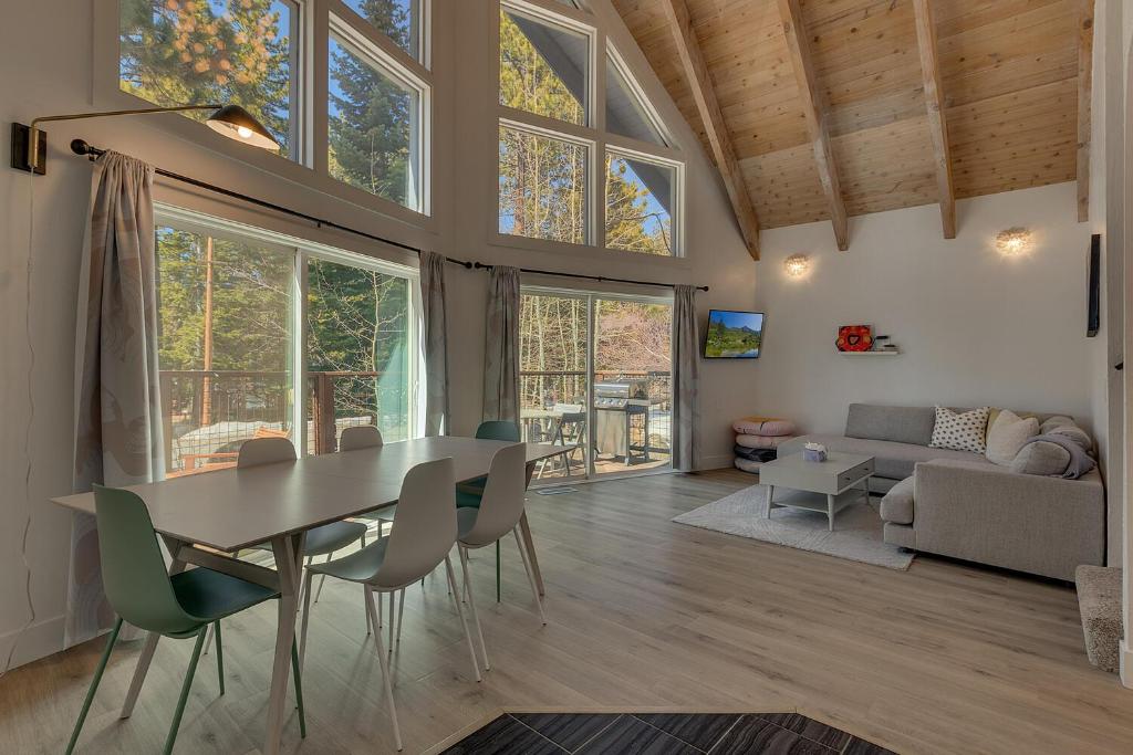 a dining room and living room with a table and chairs at Moon Dune Chalet, Remodeled 3 BR Cabin plus Loft, Walk to Dining in Tahoe Vista