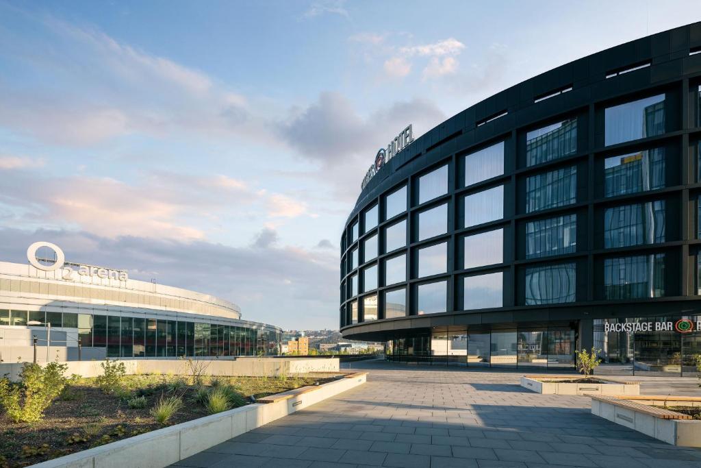a large glass building with a building at STAGES HOTEL Prague, a Tribute Portfolio Hotel in Prague