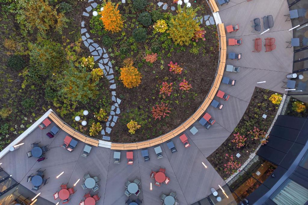 an overhead view of a garden with tables and chairs at STAGES HOTEL Prague, a Tribute Portfolio Hotel in Prague