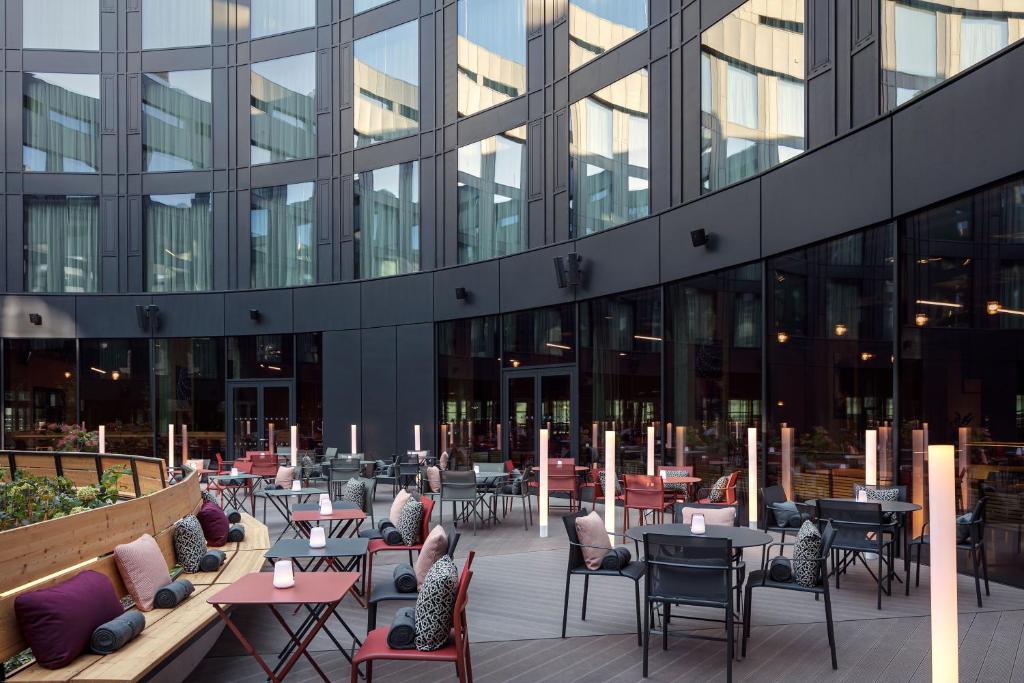 a patio with tables and chairs in front of a building at STAGES HOTEL Prague, a Tribute Portfolio Hotel in Prague