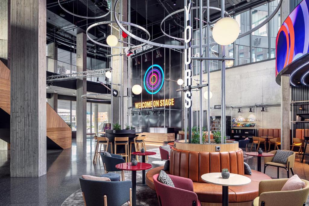 a restaurant with tables and chairs in a building at STAGES HOTEL Prague, a Tribute Portfolio Hotel in Prague