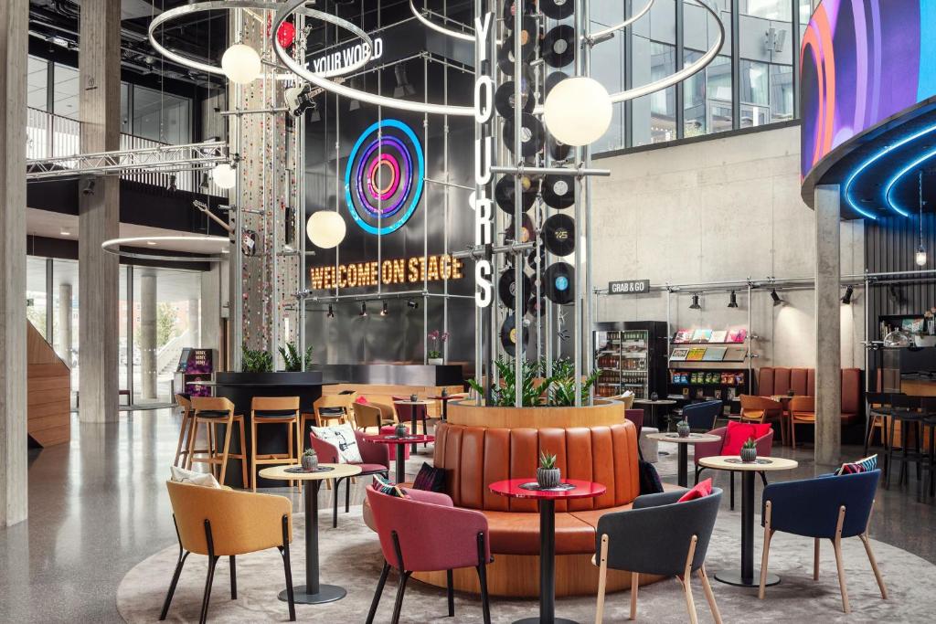 a restaurant with colorful chairs and tables in a building at STAGES HOTEL Prague, a Tribute Portfolio Hotel in Prague