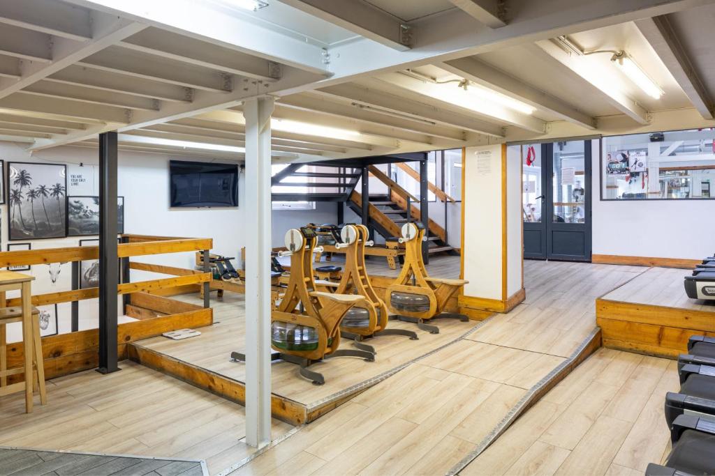 a gym with treadmills and chairs in a room at Residence Inn by Marriott Paris Didot Montparnasse in Paris