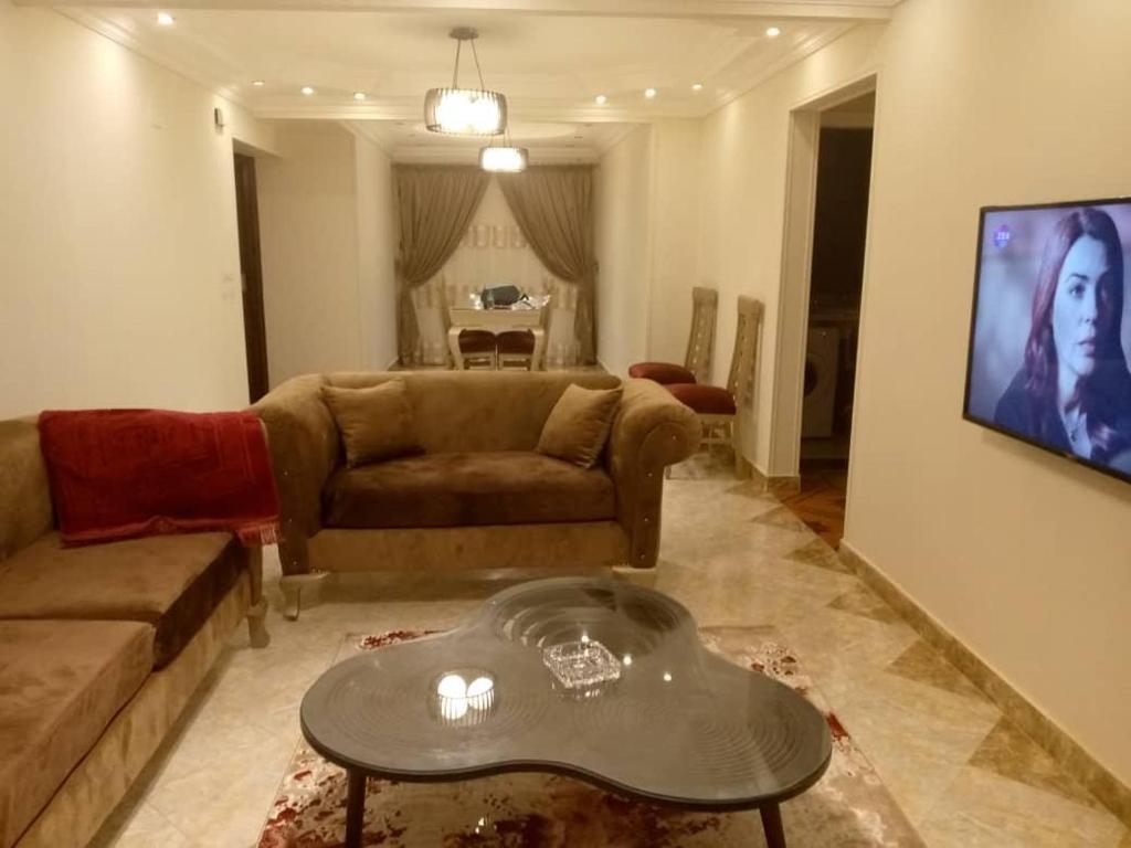 sala de estar con sofá y mesa en شقة المهندسين, en El Cairo