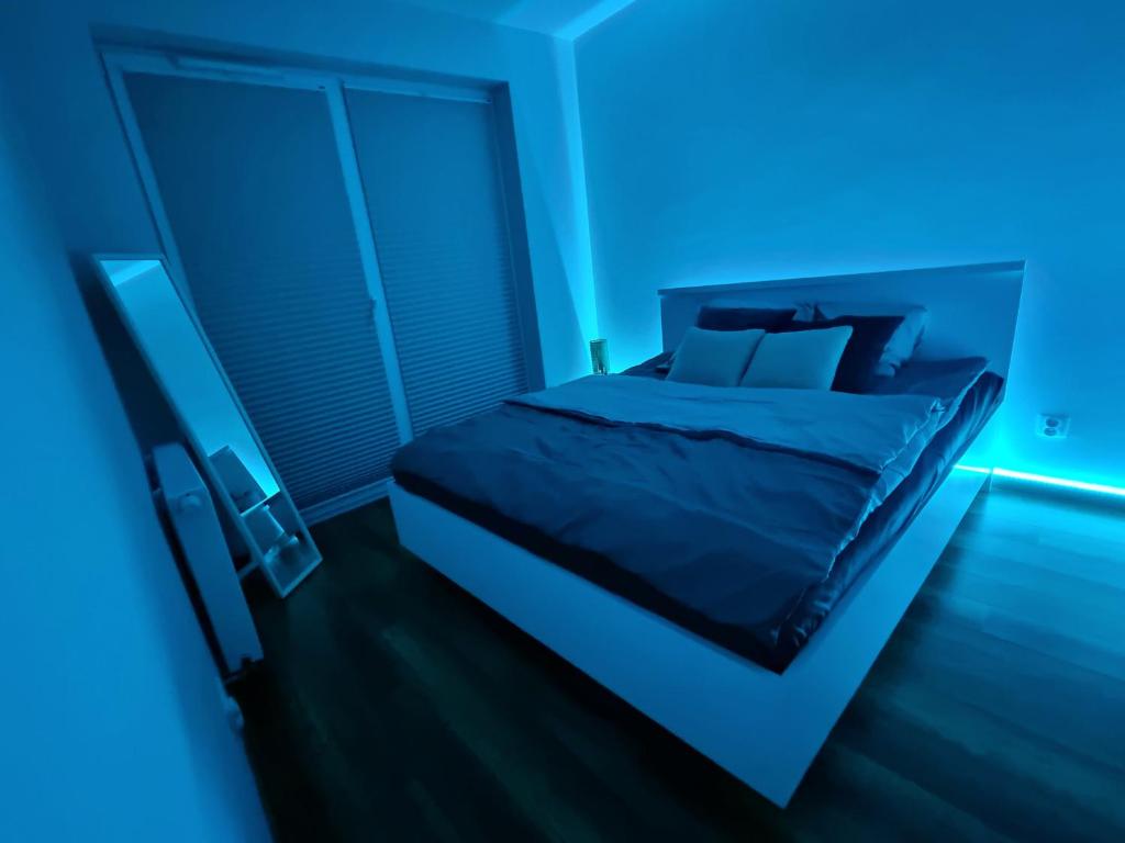 una camera blu con un letto in una stanza di Apartament przy Świebodzkim a Breslavia