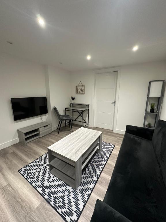 a living room with a couch and a coffee table at One Bedroom Apartment in Luton Town Centre in Luton