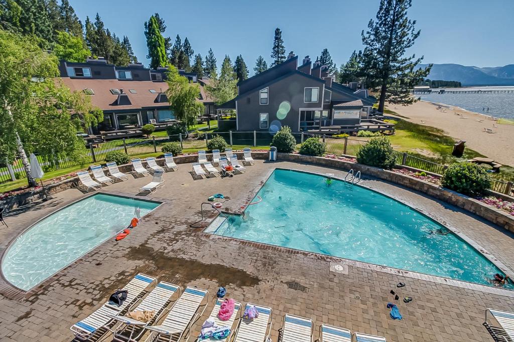 an overhead view of a swimming pool with chairs and a beach at Lakeland Village South Lake Tahoe in South Lake Tahoe