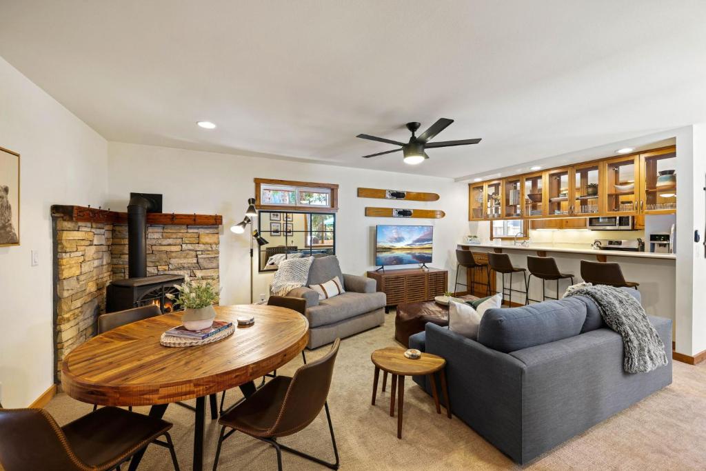a living room with a couch and a table at Sunlit Pines by Tahoe Getaways - 2BR in Tahoe Park w Hot Tub, Fenced Yard & Pet Friendly! in Tahoe City
