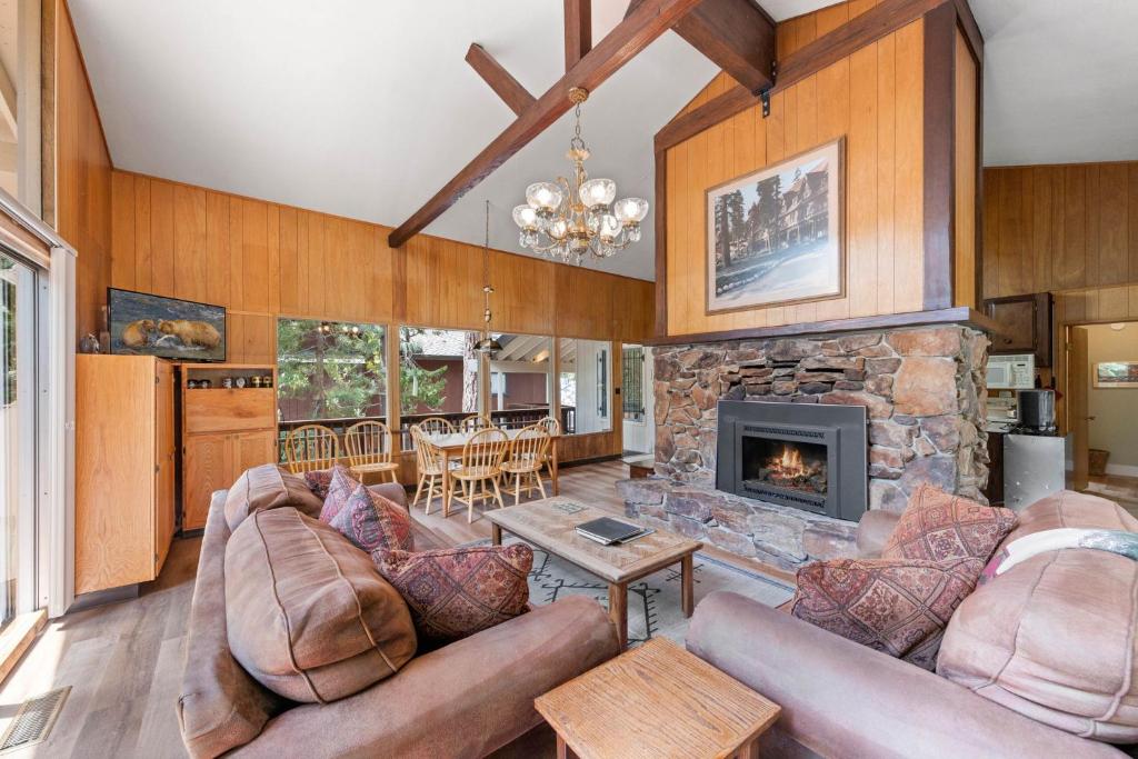 a living room with couches and a stone fireplace at Starry Skies on the West Shore, Private Beach, Fireplace, Pet Friendly, Close to Ski Resorts in Tahoe City