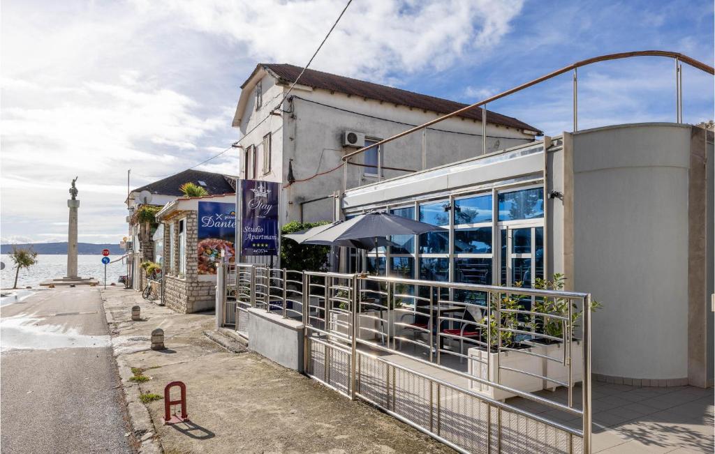 a building with a restaurant on the side of a street at Stunning Apartment In Kastel Novi With Jacuzzi in Kaštela