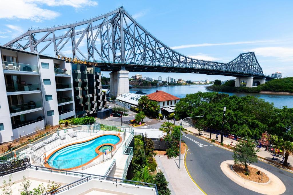 a view of a bridge with a swimming pool at Story Bridge view apartment with parking and pool in Brisbane