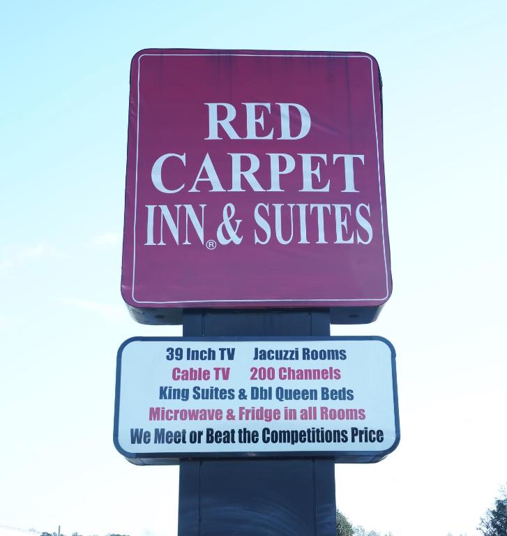 a sign for a red carpet inn and suites at Red Carpet Inn & Suites in Newnan