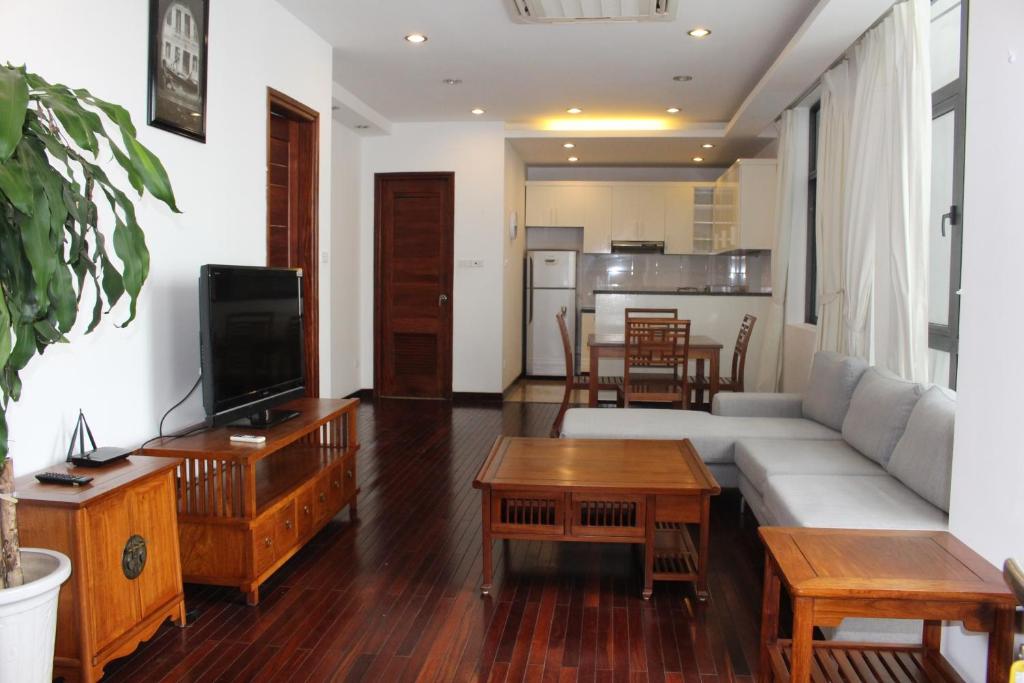 a living room with a couch and a tv at Davidduc's Duplex Apartment Xom Chua (5F) in Hanoi