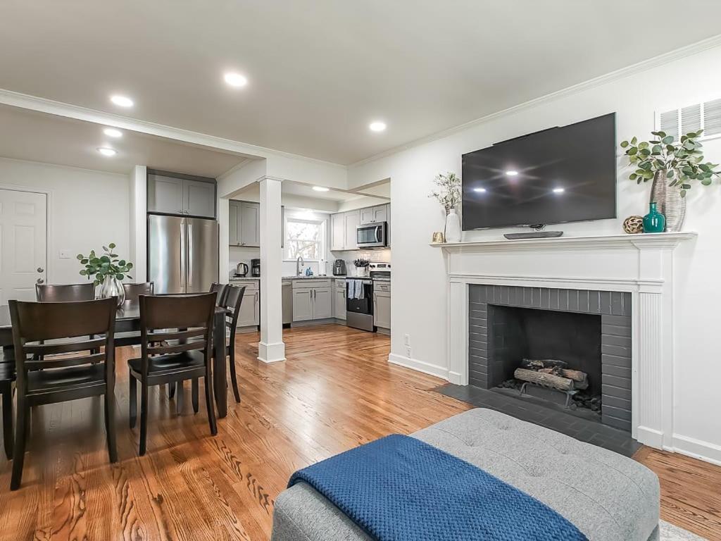 a living room with a dining table and a fireplace at 4 Bedroom Plaza Charmer Pet Friendly in Kansas City